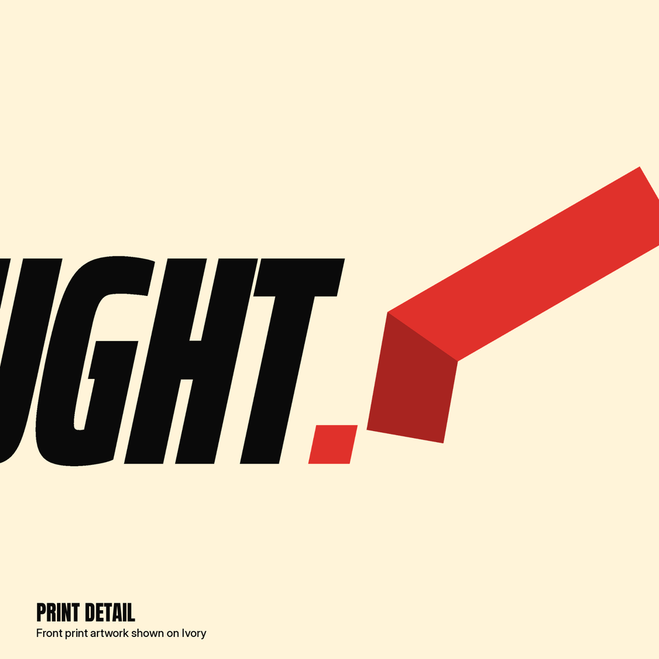 Close-up of the Caught Flag Tee print on ivory: black italic letters UGHT, red period, red folded flag rising to the right.