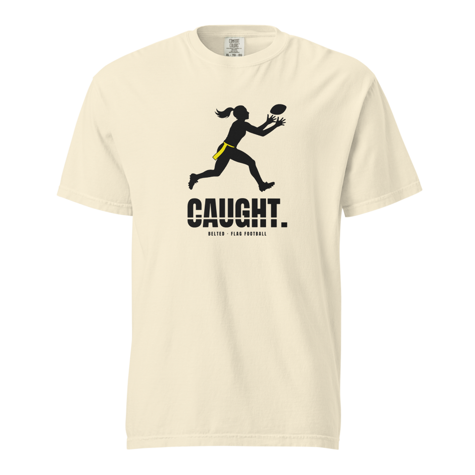 Caught Tee in Ivory, front: black player silhouette with yellow flag reaching for a ball, CAUGHT. and Belted Flag Football