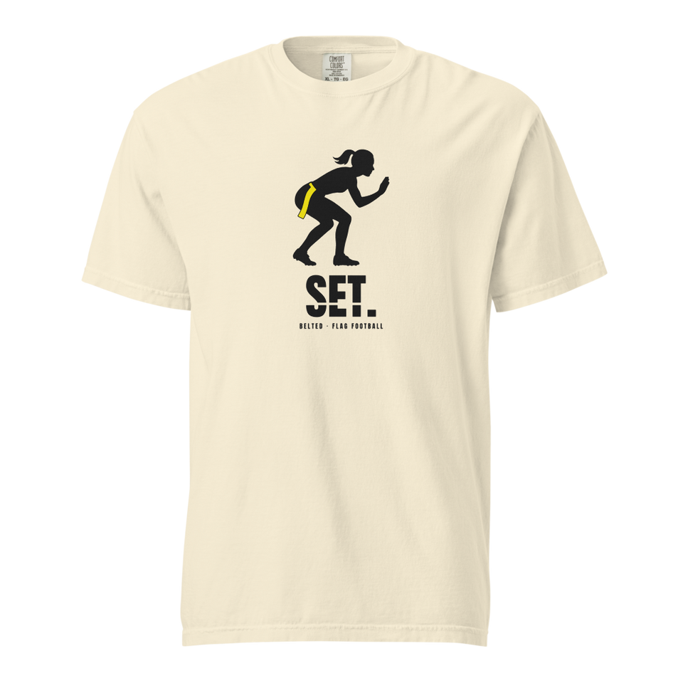 Ivory Set Tee, front: black crouching player silhouette with a yellow flag at the hip, SET. and Belted - Flag Football below