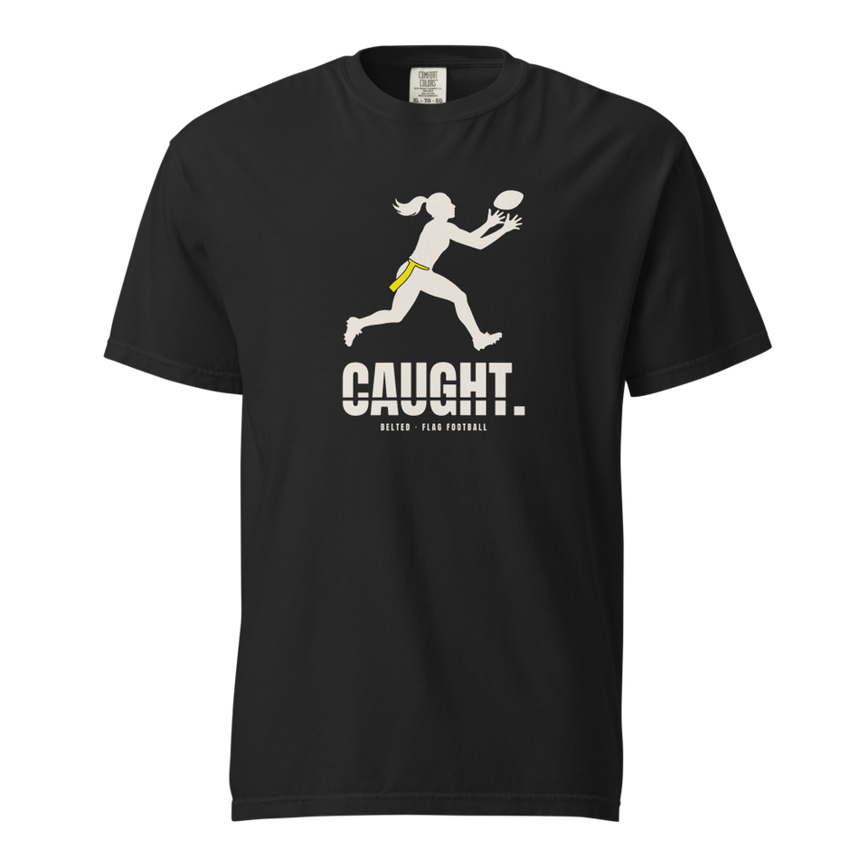 Caught Tee in black, front: Ivory player silhouette with yellow flag reaching for a ball, CAUGHT. and Belted Flag Football