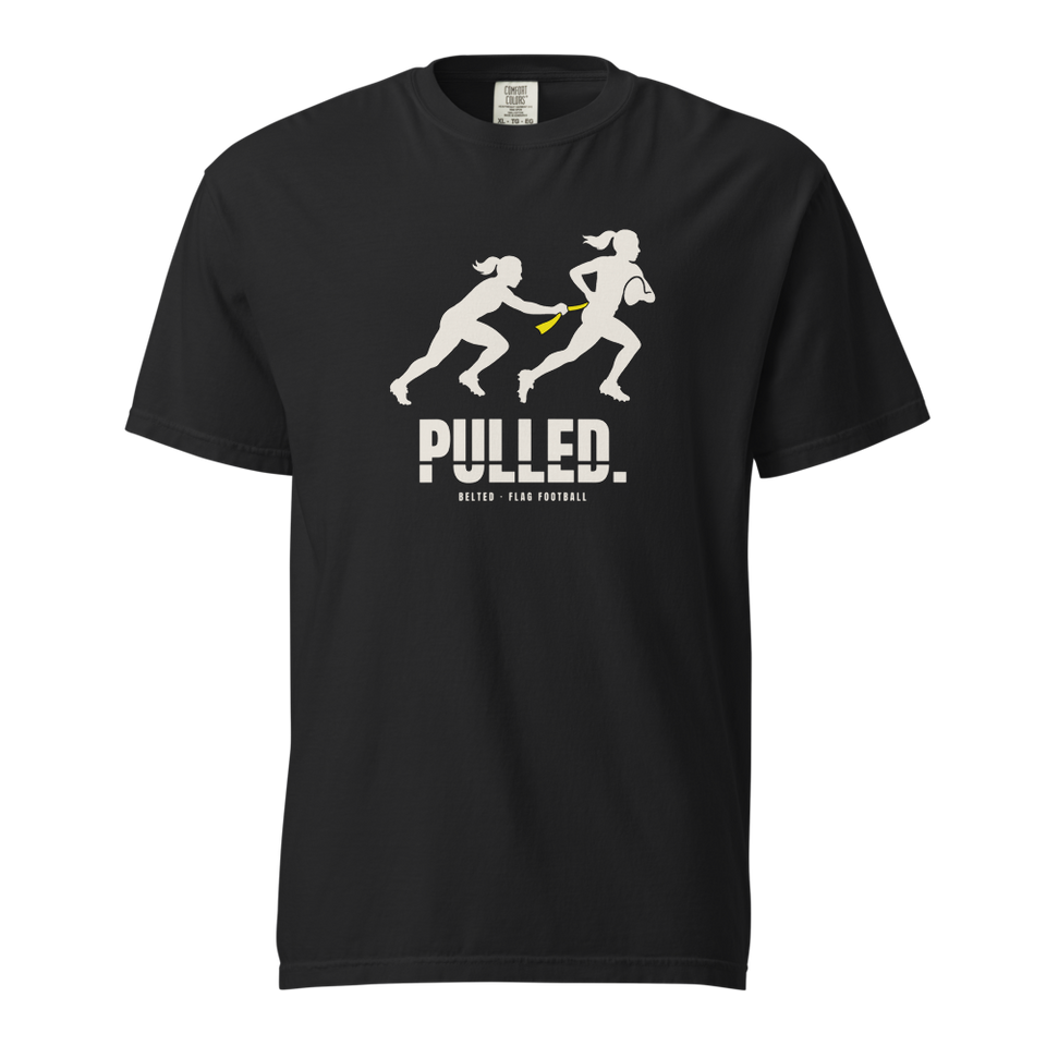 Black Pulled Tee, front: Ivory silhouette of one player pulling a yellow flag from another, PULLED. below